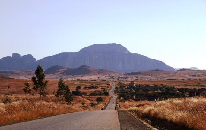 Scenic view of Southern Madagascar road with rocky mountains and golden savanna vegetation — with Discover Madagascar